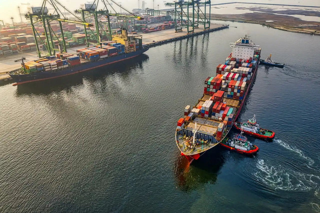 A large container ship loaded with stacked shipping containers at sea