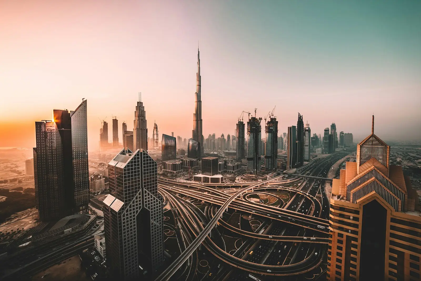 The Burj Khalifa and Dubai skyline above a multi-level highway