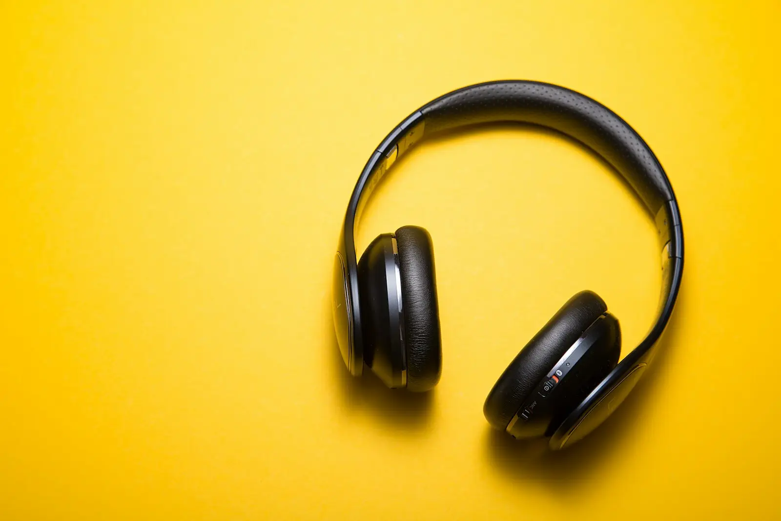A pair of over-ear headphones on a plain background